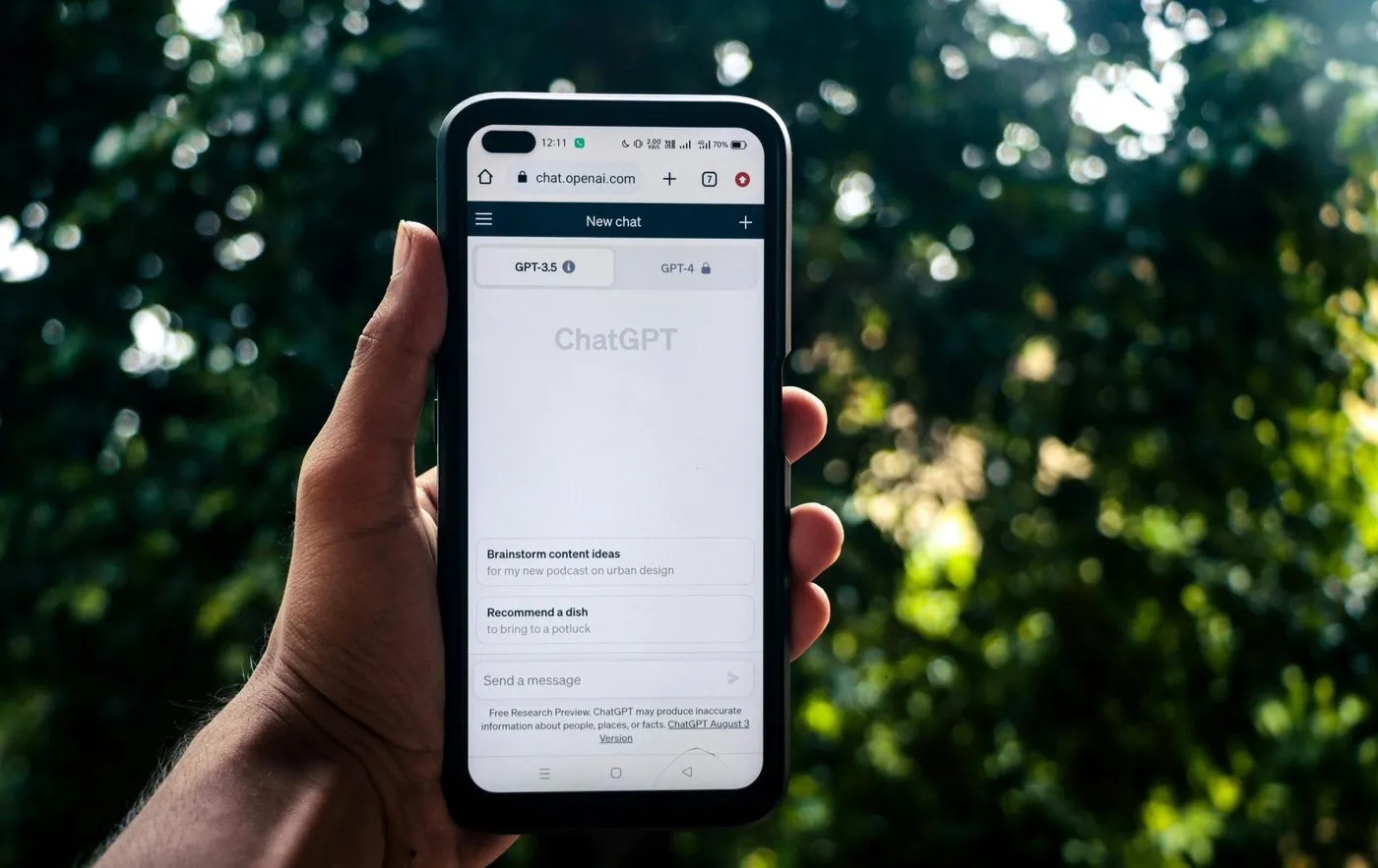 A hand holding a phone showing ChatGPT, representing AI-driven content discovery.