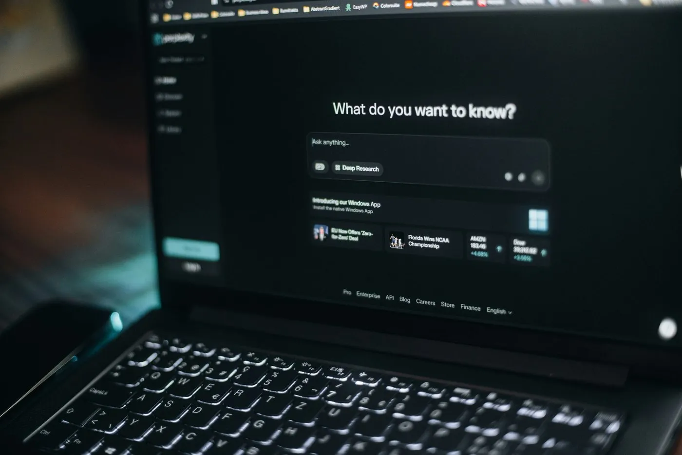 A laptop screen showing a search bar in the Perplexity dashboard.