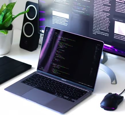 Laptop on a desk with code, representing a B2B SaaS company building software products.
