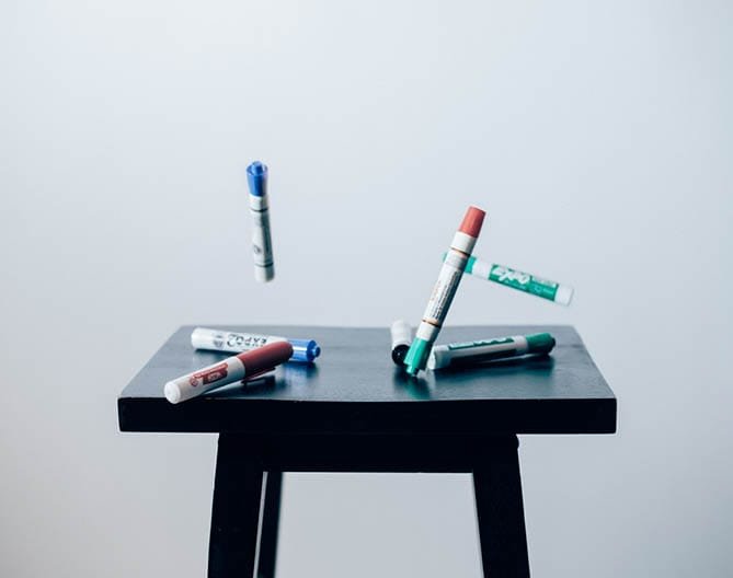 Markers on a table, symbolising creative SEO content production.