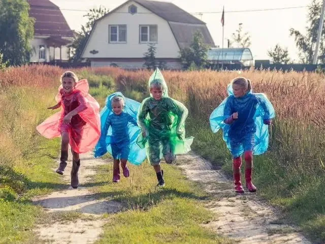 Children in colorful costumes running joyfully.