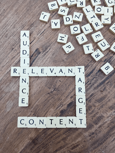 Scrabble tiles form "Audience," "Relevant," "Target," "Content," symbolizing SEO agency services for startups and B2B growth.