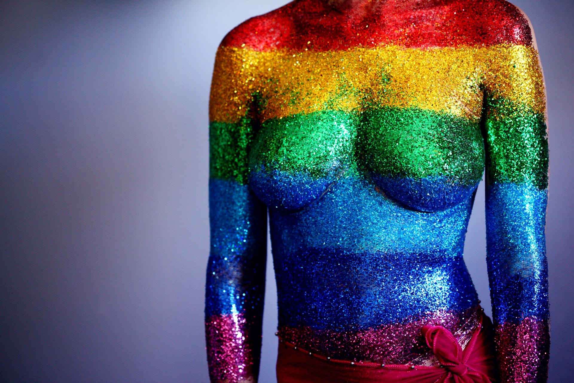A vibrant rainbow glitter body art symbolizes diversity, reflecting the creative spirit of a dynamic SEO agency for startups.