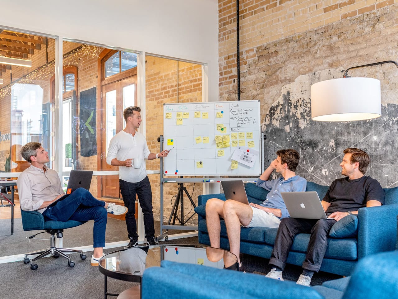 A team discusses strategies at an SEO agency for startups, focusing on AI SEO, B2B SaaS, content, and link building services.