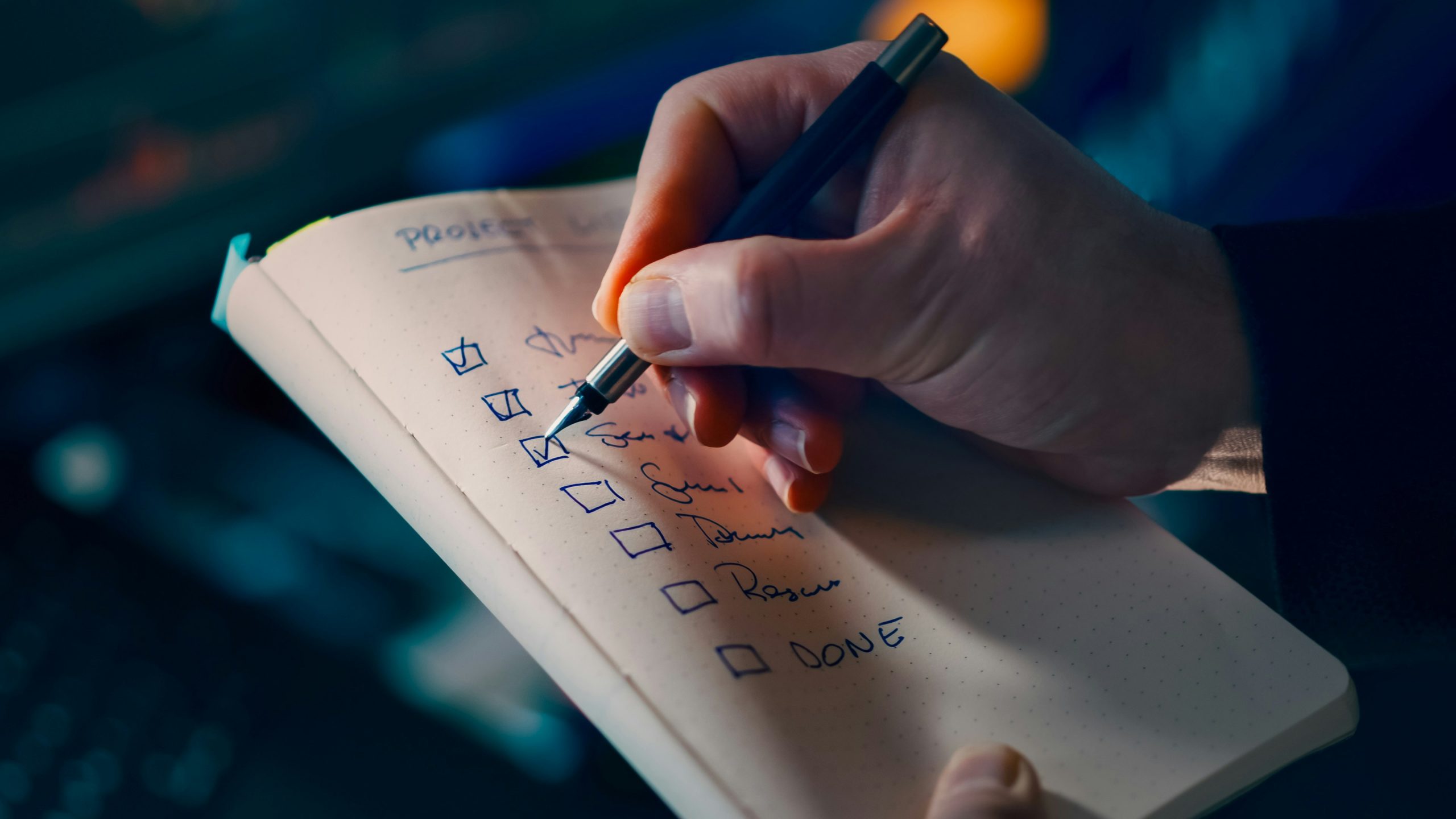 Someone writing a to-do checklist.