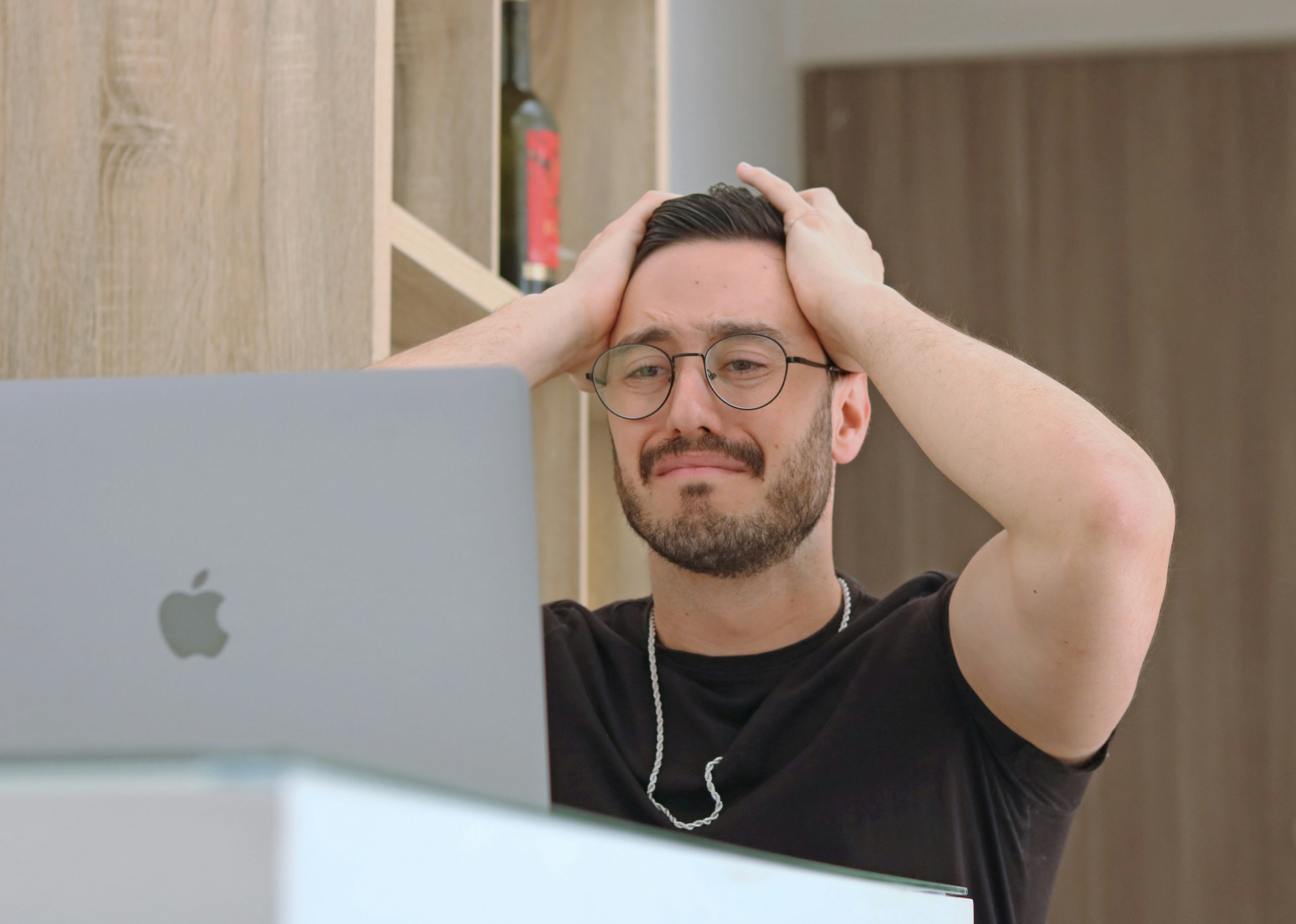 A person holding his head in disbelieve.